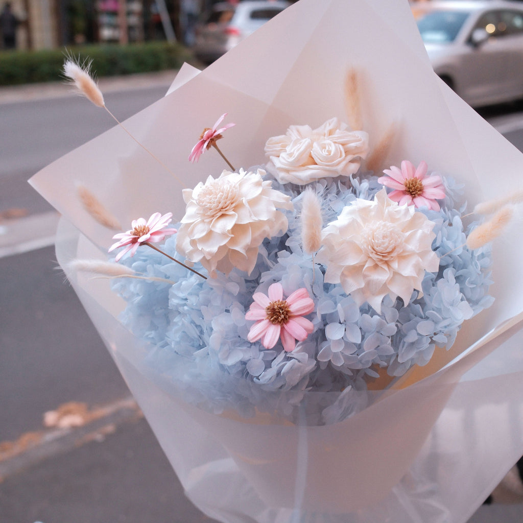 Blue Love dried and preserved flower bouquet held outside Hanaya Flora, Surry Hills