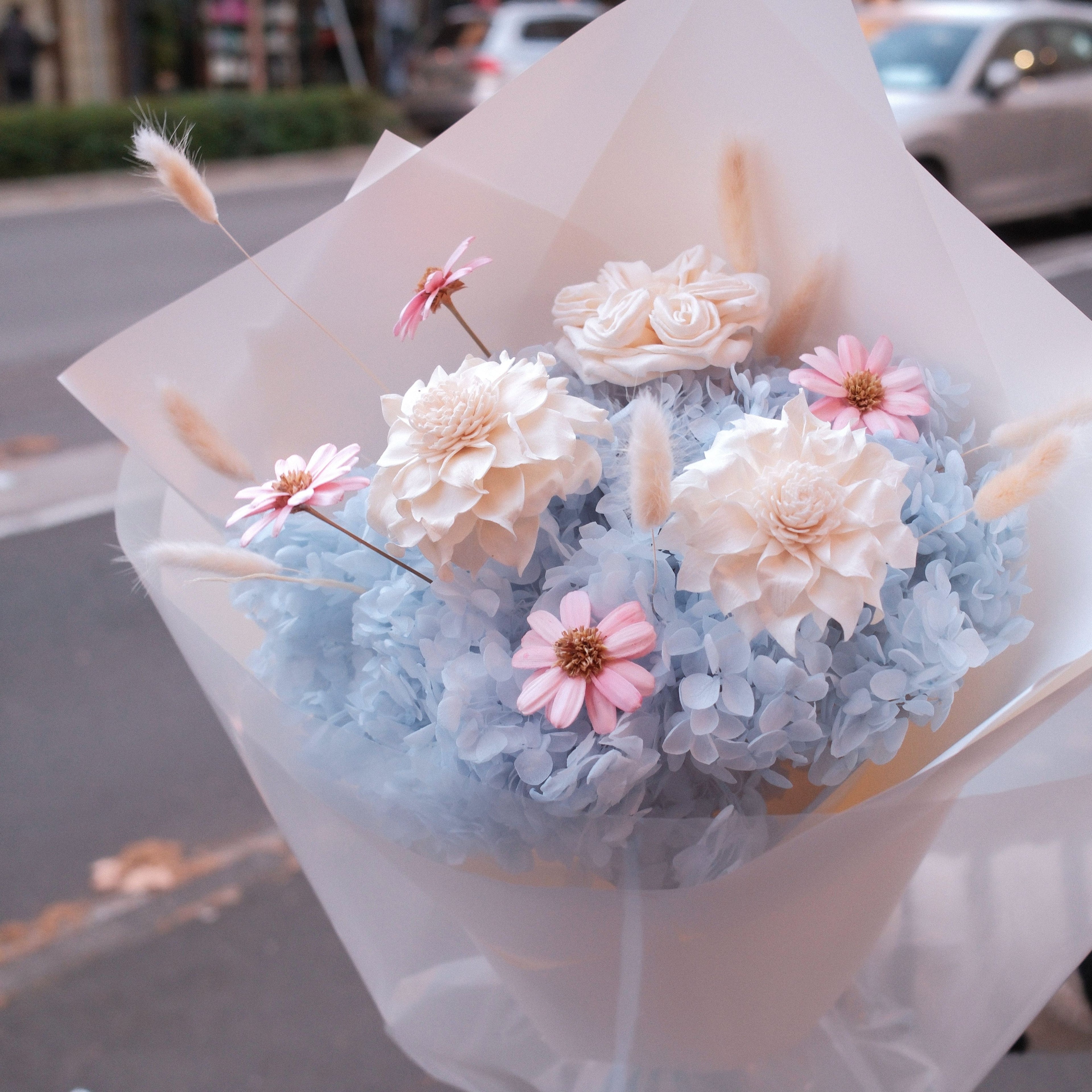Blue Love dried and preserved flower bouquet held outside Hanaya Flora, Surry Hills