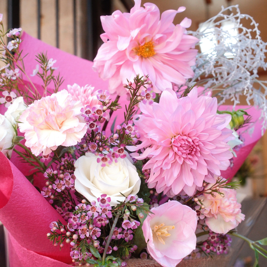 Close-up of Blush Bloom bouquet with pink dahlia, white rose and waxflower