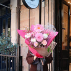 Woman holding Blush Bloom bouquet outside Hanaya flower shop in Sydney