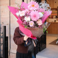 Blush Bloom bouquet detail showing pink carnation, dahlia and dried grass accents