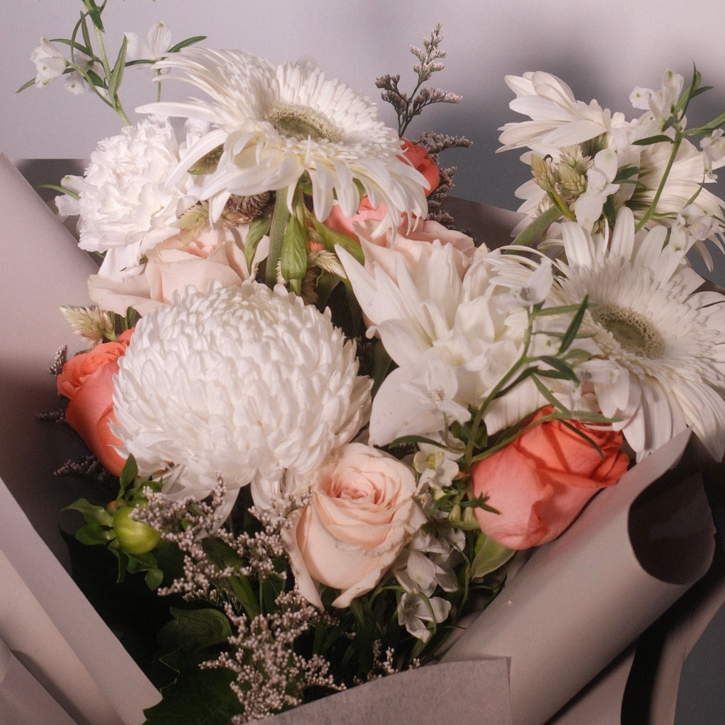 Close-up of Cherished bouquet with ivory and blush peach blooms