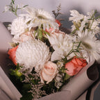 Close-up of Cherished bouquet with ivory and blush peach blooms