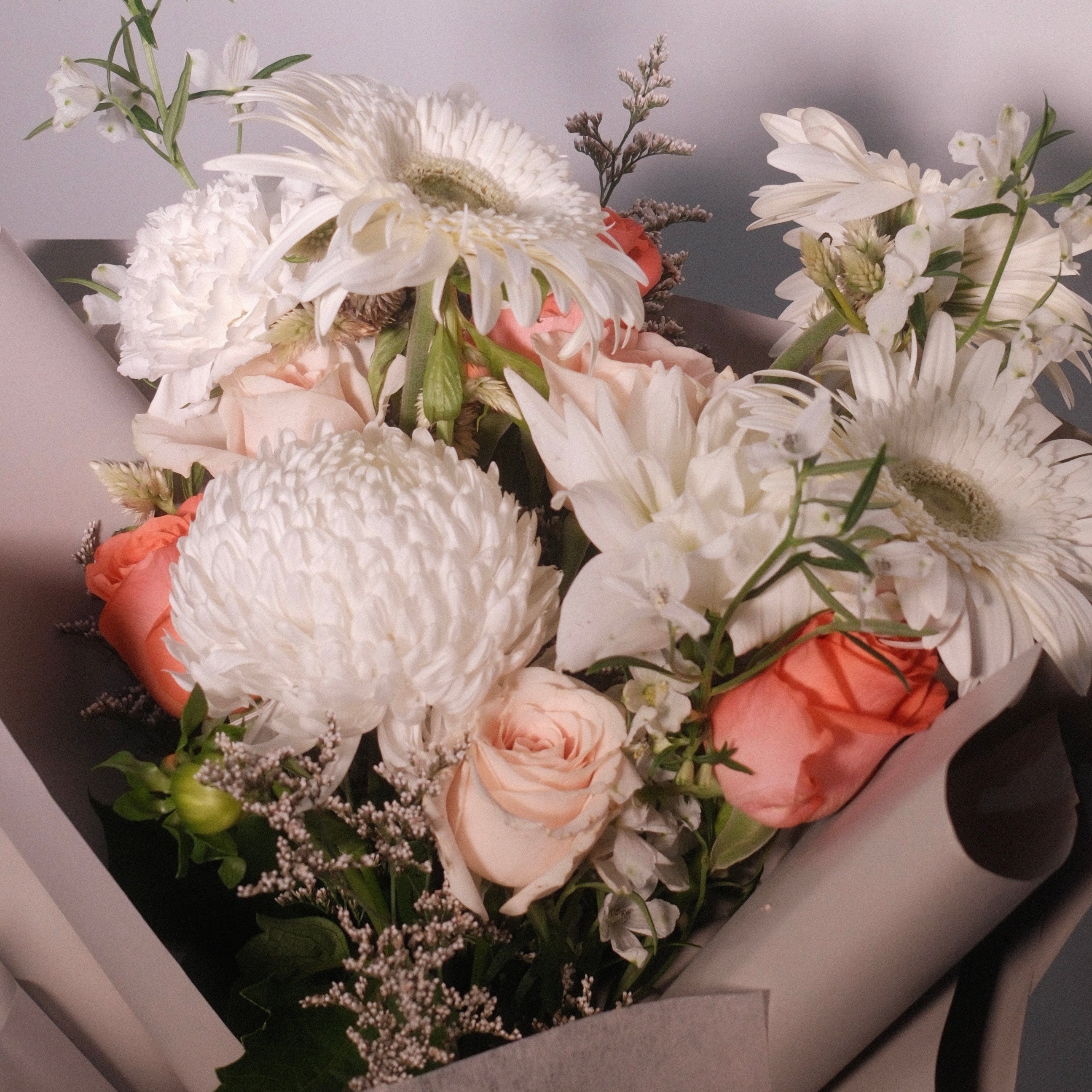 Close-up of Cherished bouquet with ivory and blush peach blooms
