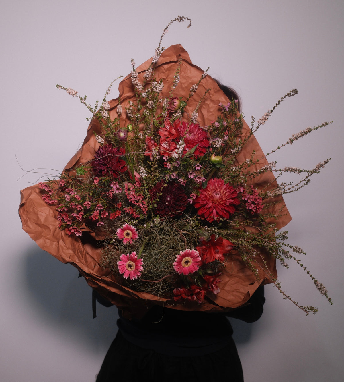 Flower bouquet of wild flowers, daisy, dahlia wrapped in brown paper, by Hanaya Flora, Surry Hills, Sydney. 