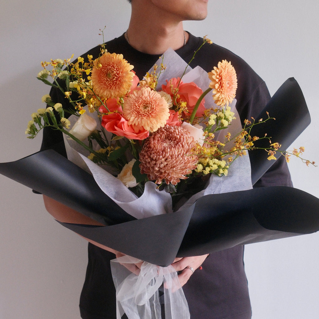 Florist holding the Megumi Sunrise bouquet, a thank you gift, Sydney