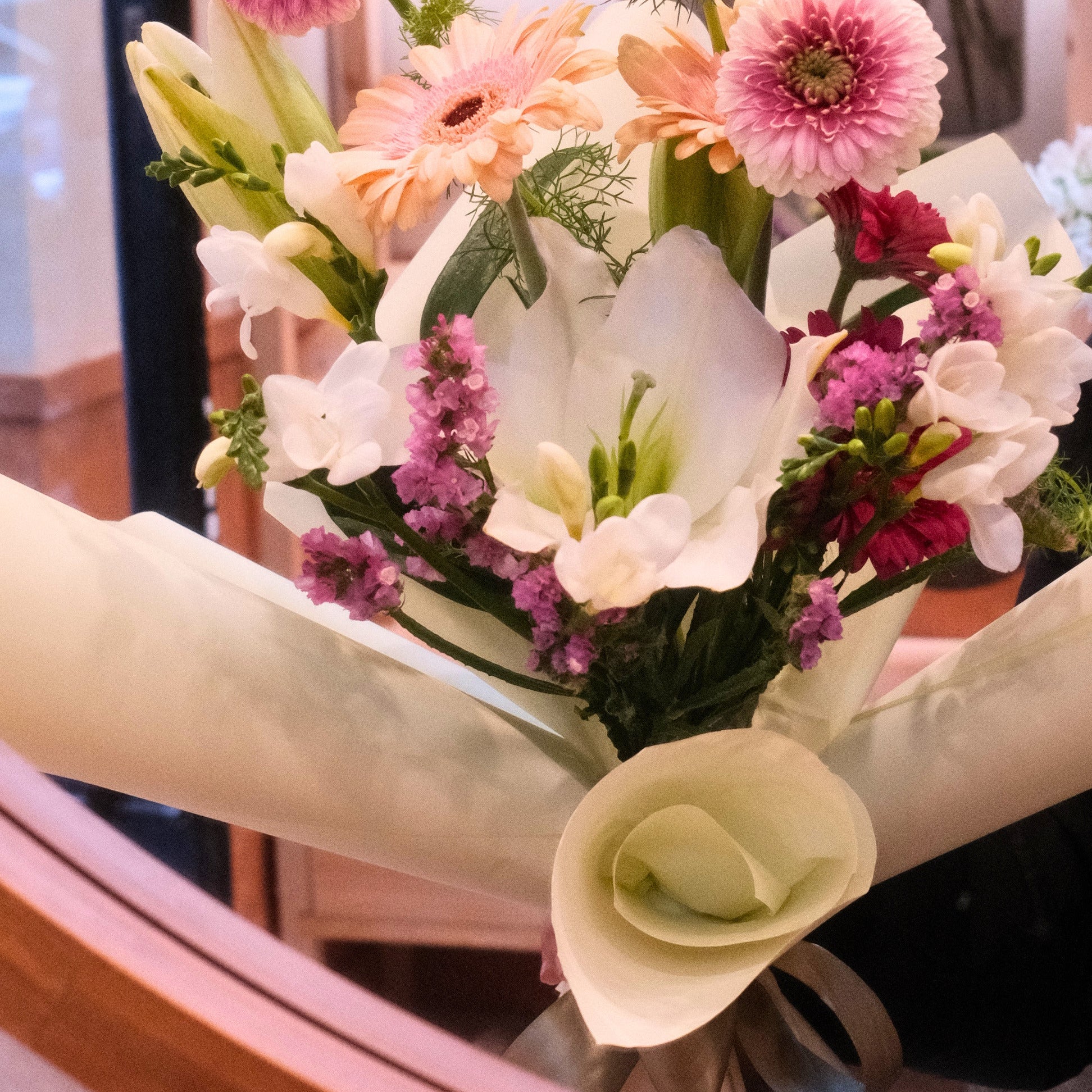Florist holding the Yume Melody bouquet inside the Surry Hills flower shop