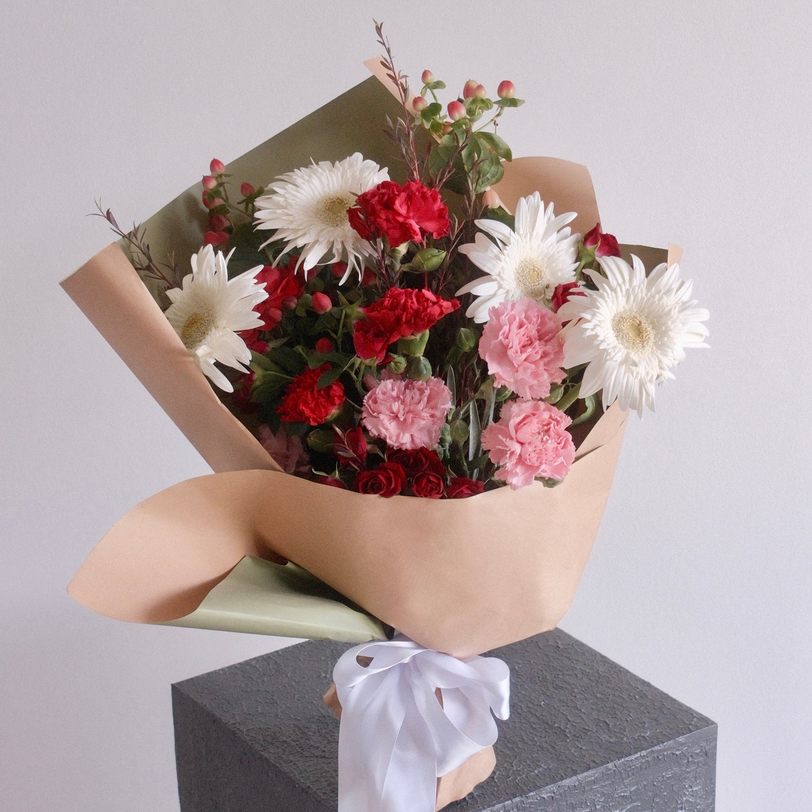Red, pink and white gift bouquet styled on a pedestal, Sydney flower delivery