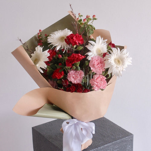Red, pink and white gift bouquet styled on a pedestal, Sydney flower delivery