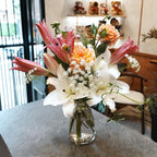Hana-Akari vase arrangement of white and pink lilies, peach dahlias and Queen Anne's lace in a clear glass vase