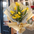 Florist holding the Harezora tulip bouquet, a seasonal birthday flower gift, Sydney