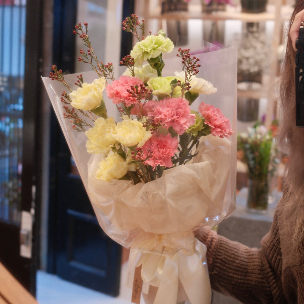 Florist holding the Hatsuhana carnation bouquet in our Surry Hills flower shop
