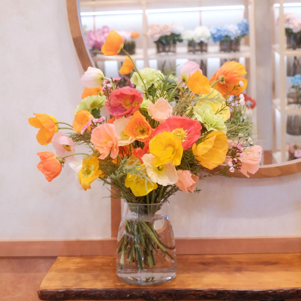 Hinata August birthday bouquet, medium size, with colorful poppies in a clear glass vase