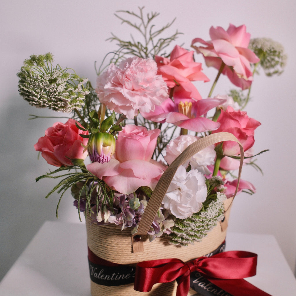 Home in Bloom woven basket arrangement with roses and seasonal blooms, a romantic gift, Sydney