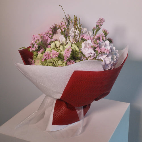 Lovely bouquet of hyrangeas wrapped in red and white paper, a perfect gift for her delivered by Hanaya Flora, based in Sydney.