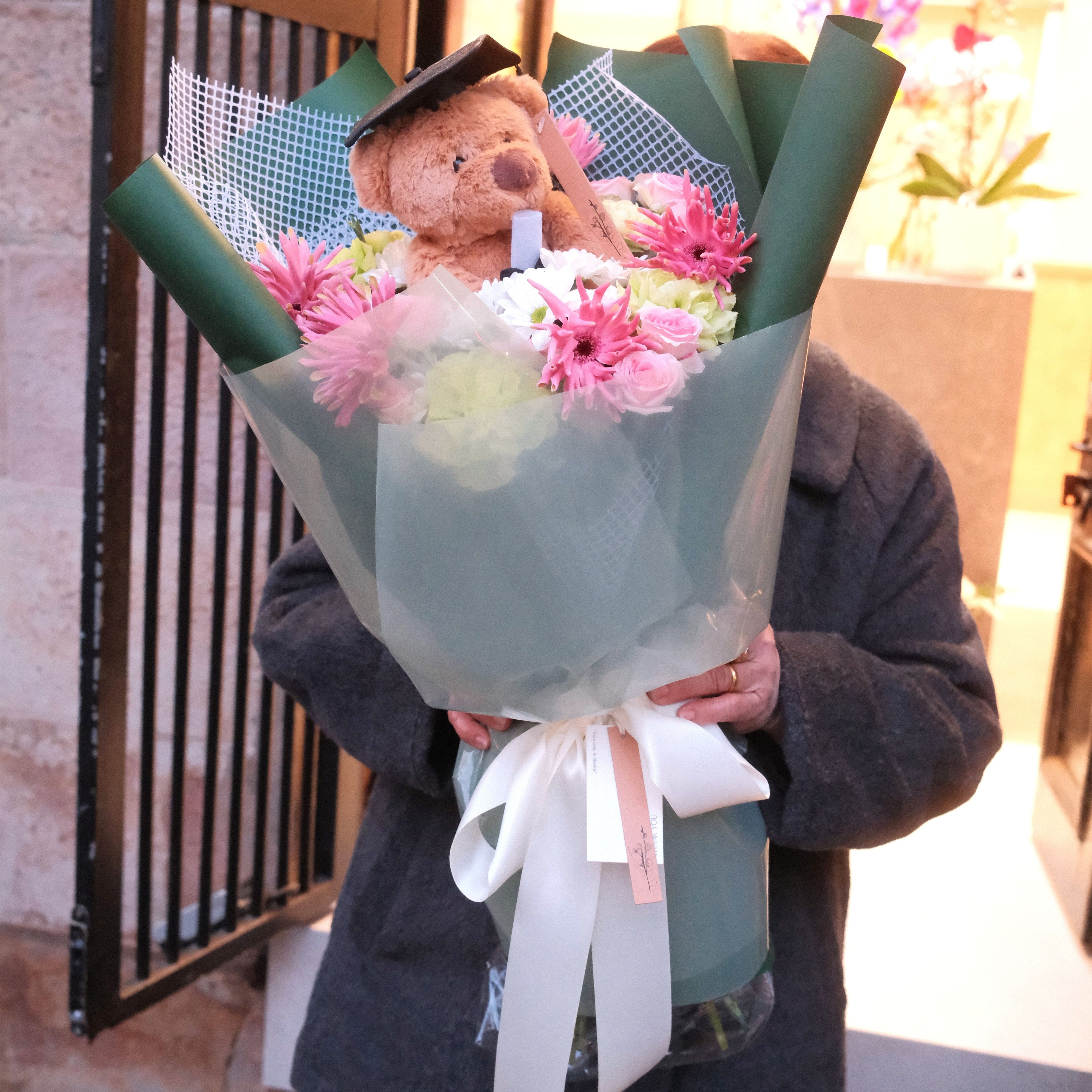 Florist holding the Kuma Honour graduation bouquet, a congratulations gift, Sydney