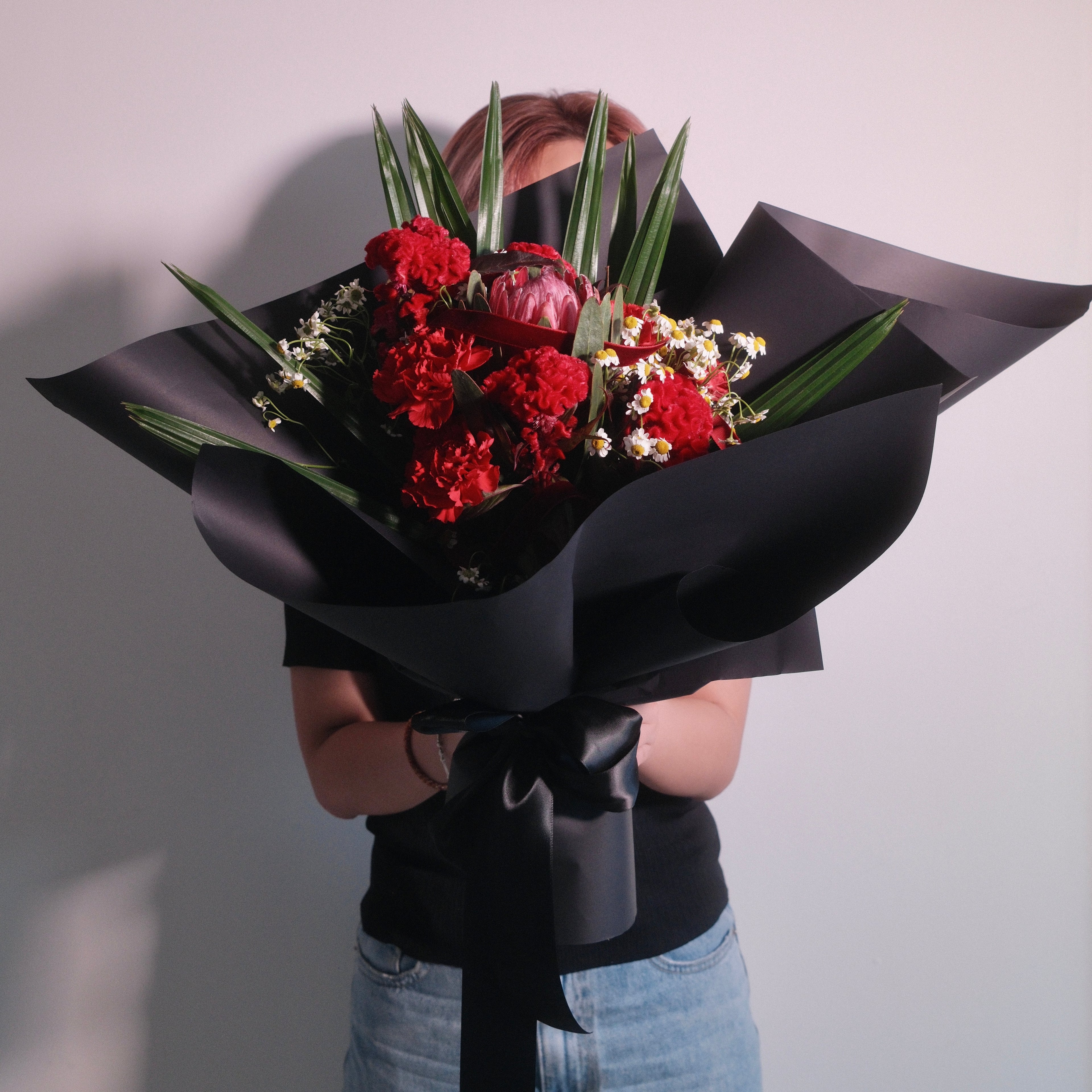 Florist holding the Kunerai Grace bouquet, a flowers for mum gift from Surry Hills