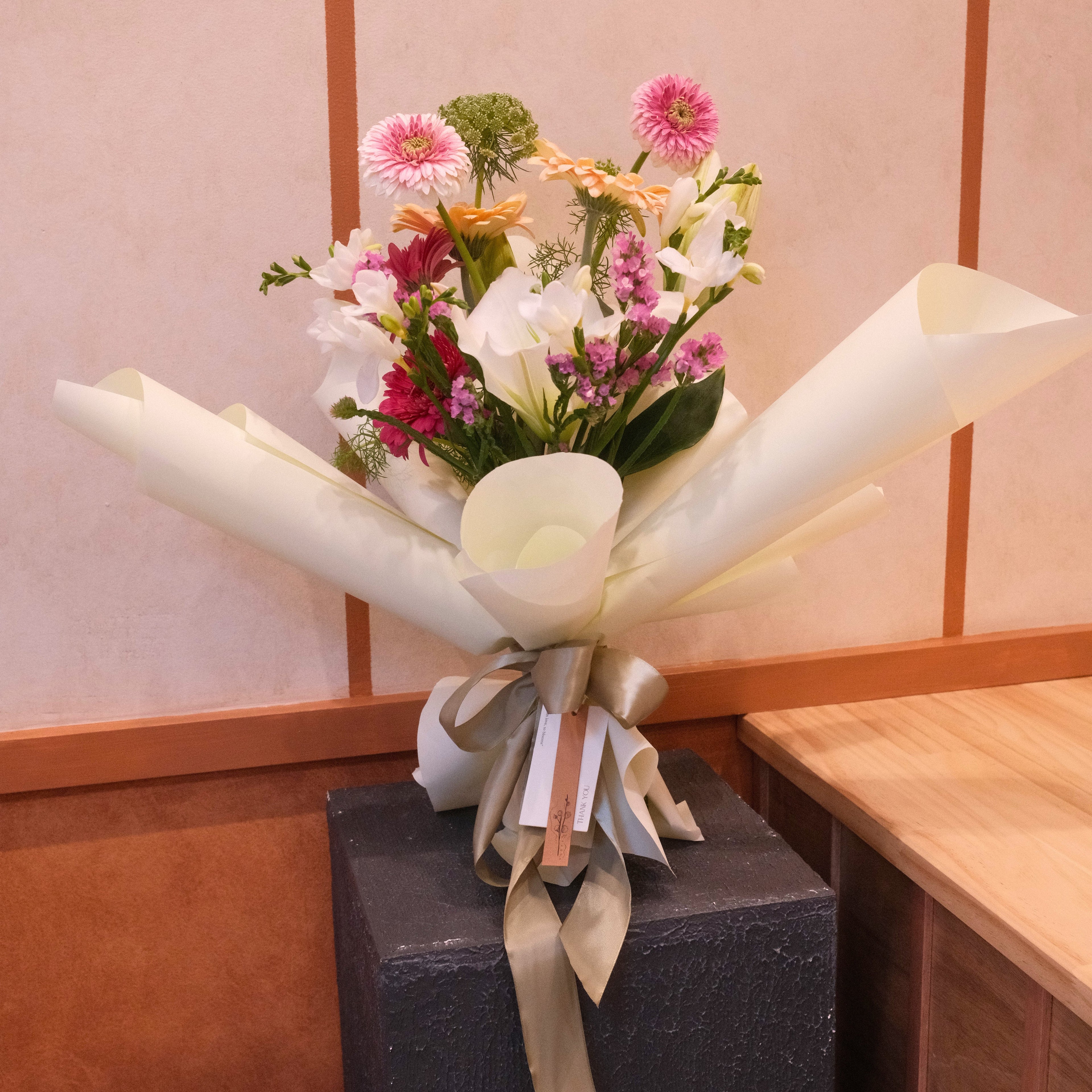 Bouquet of flowers wrapped in pale green paper, perfect flower gift for her made by Hanaya Flora, Surry Hills, Sydney.