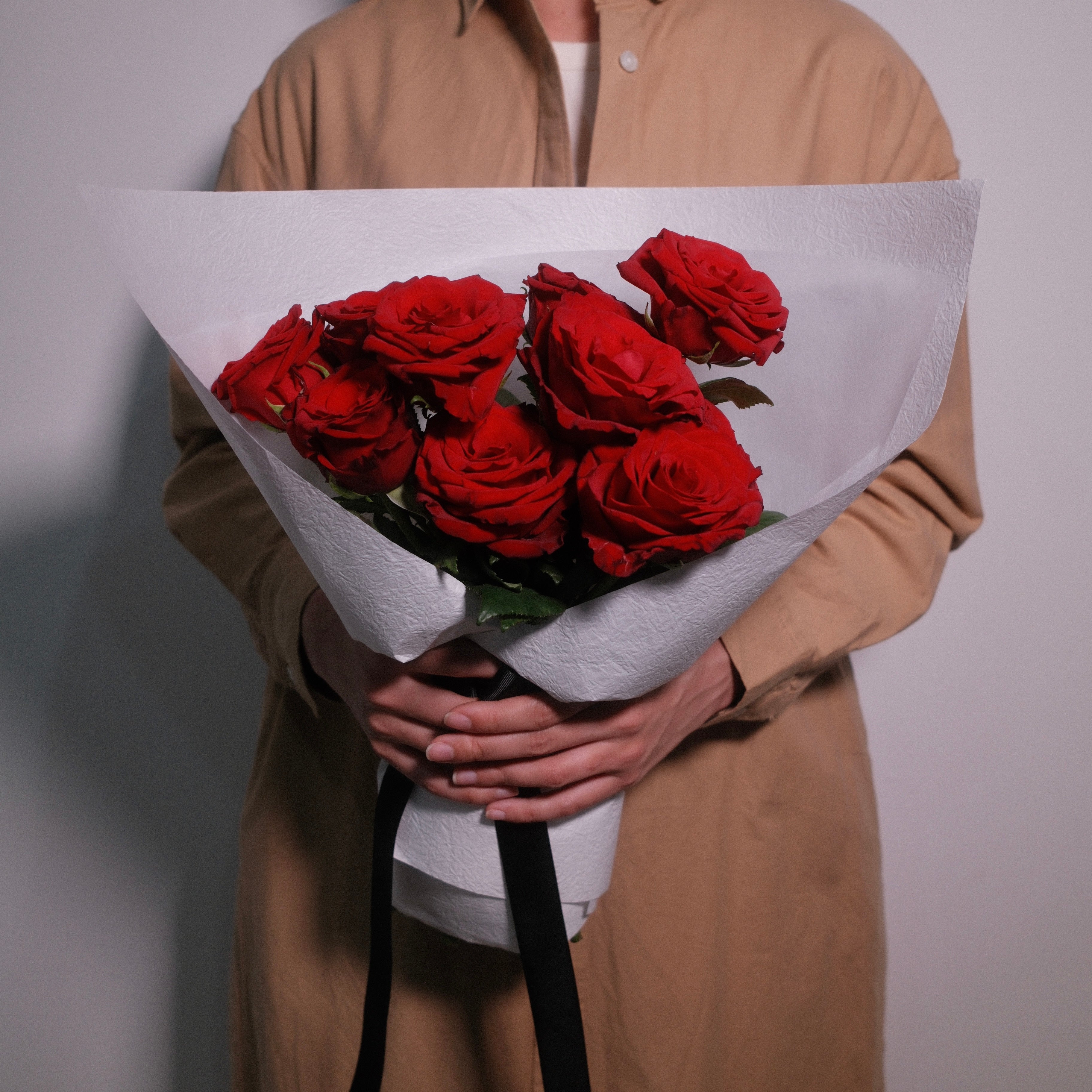 Premium flower bouquet of red roses wrapped in white paper with a black ribbon, by Hanaya Flora, Surry Hills, Sydney.