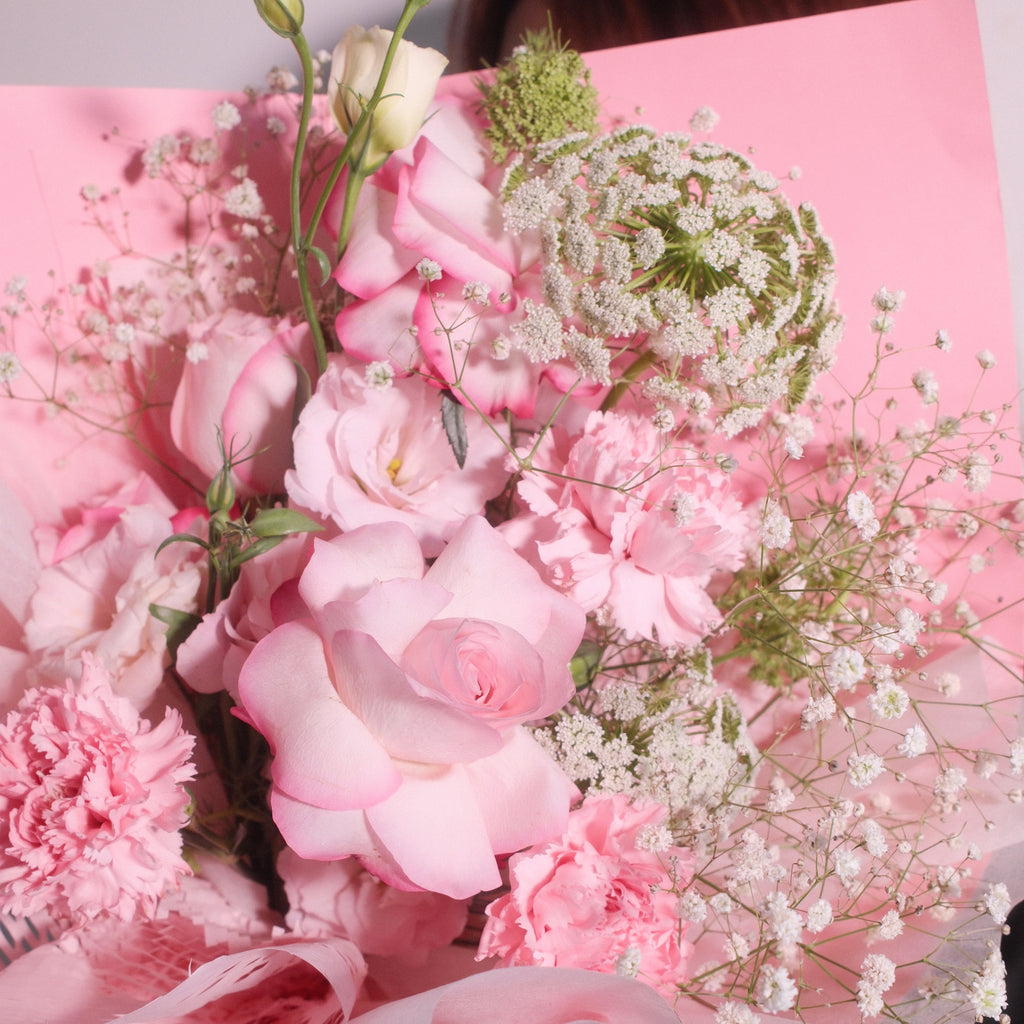 Close-up of Blossom Pride bouquet with pink roses, carnations and baby's breath