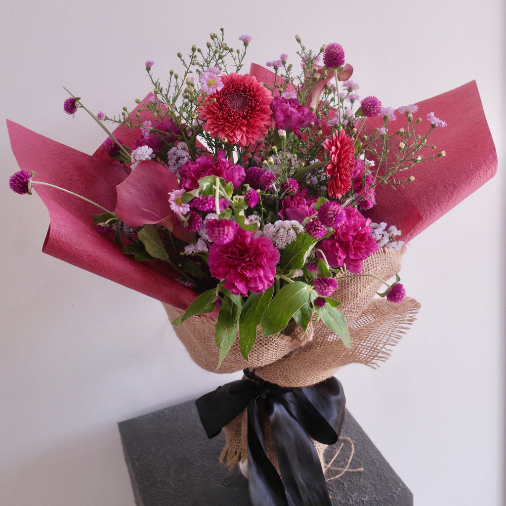 Magenta Heart bouquet in burgundy wrap, a bold I love you gift