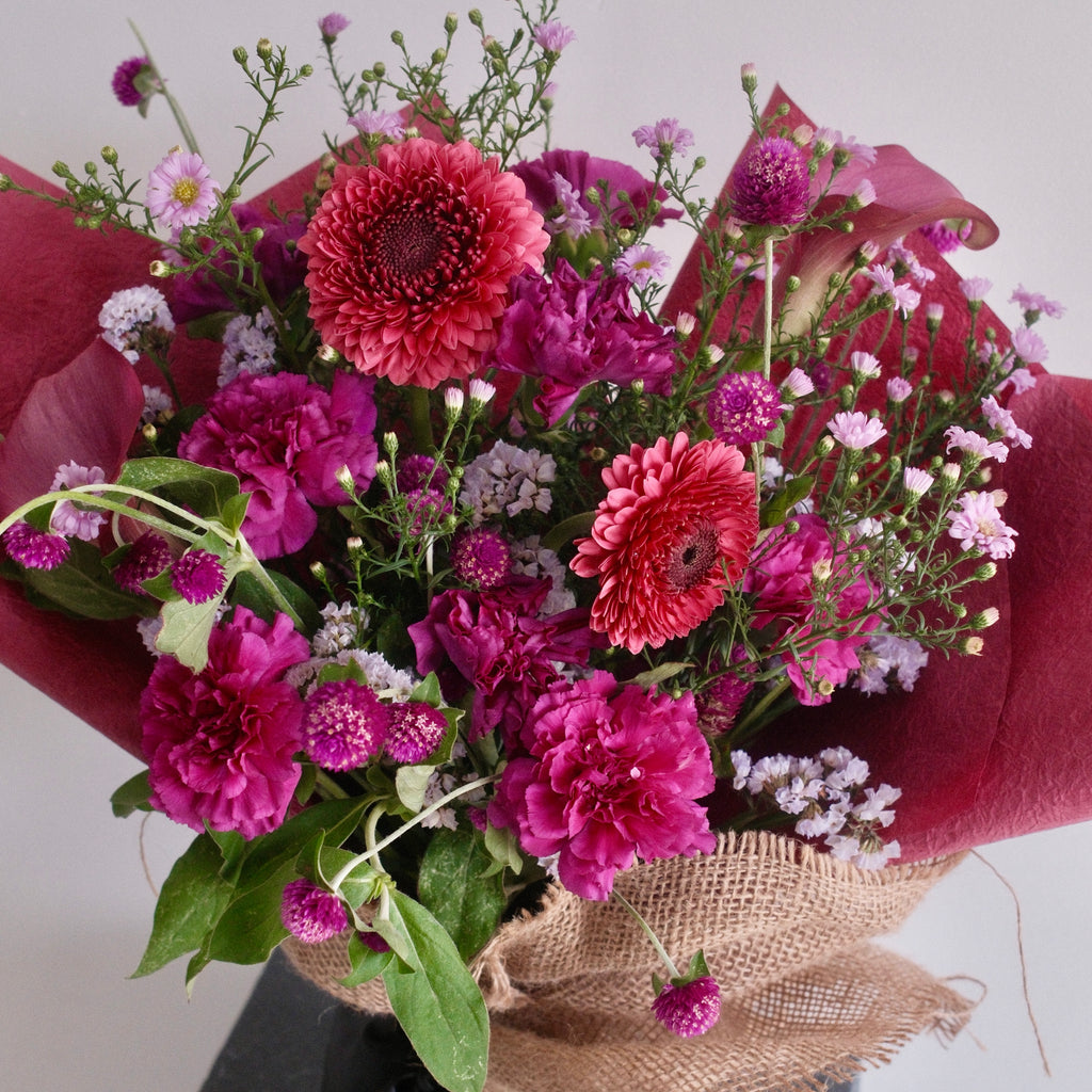 Magenta Heart jewel-toned bouquet styled on a pedestal, a romantic gift, Sydney