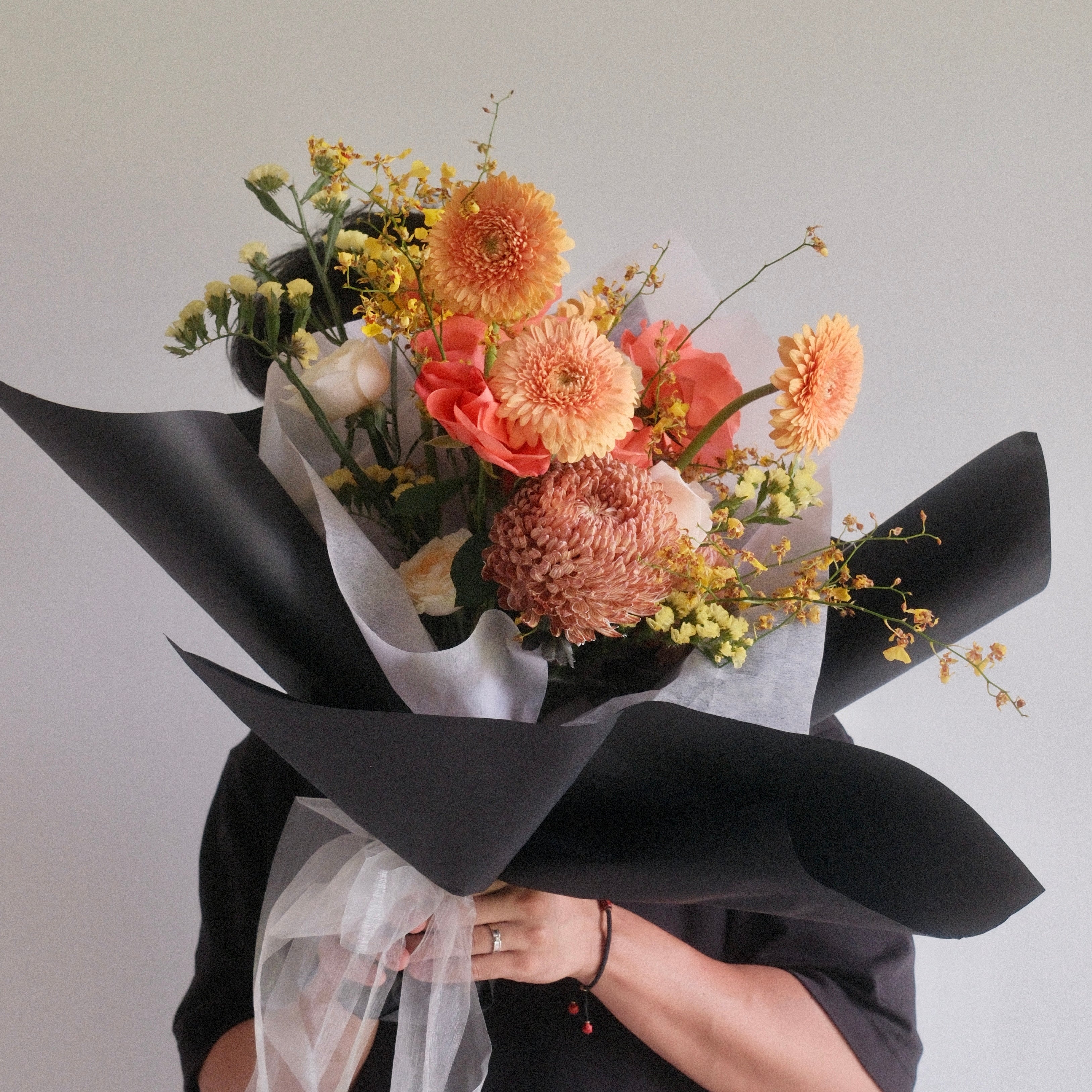 Florist holding the Megumi Sunrise bouquet, a flowers for mum gift from Surry Hills