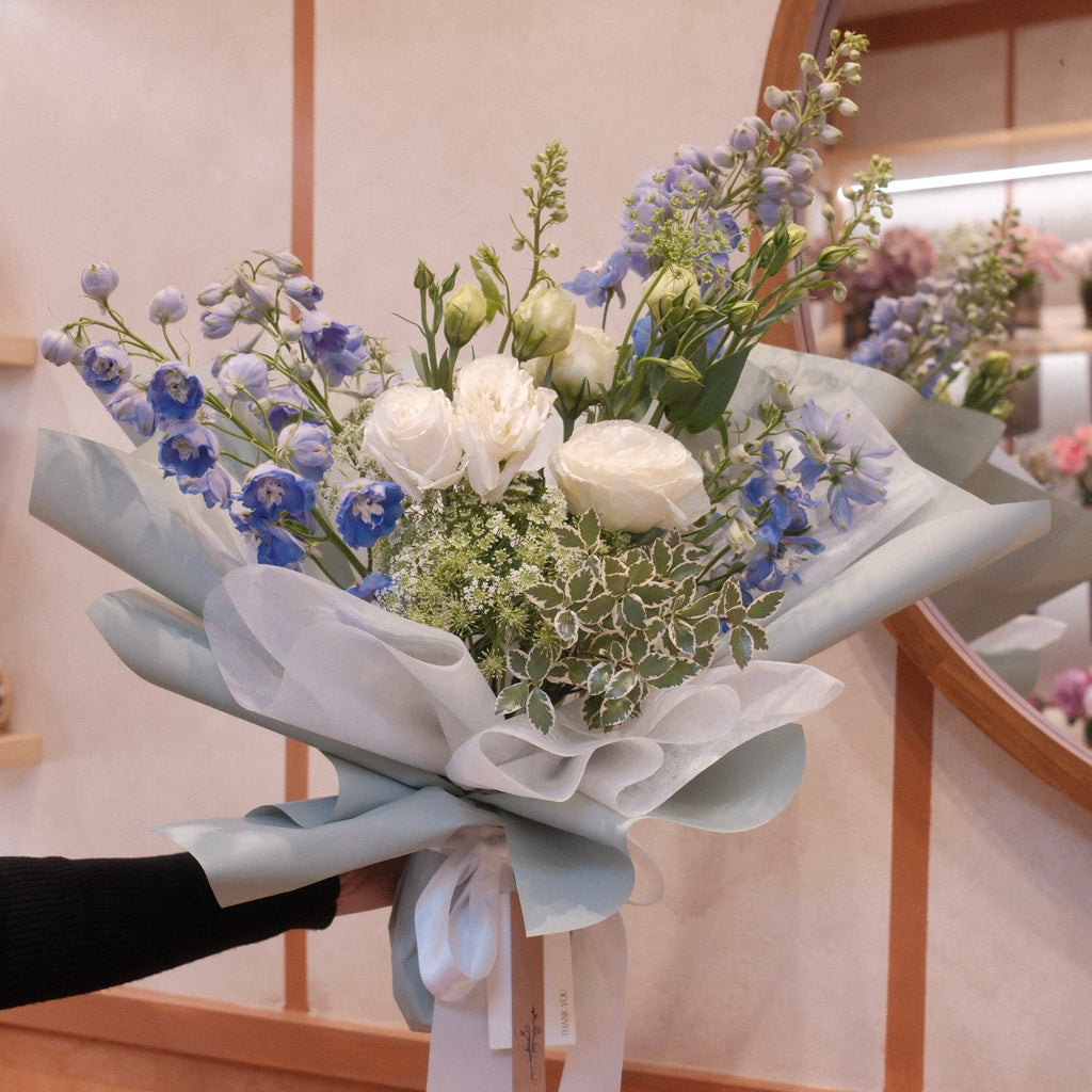 Florist holding the Natsuzora July birthday bouquet in our Surry Hills flower shop, Sydney