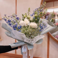 Florist holding the Natsuzora July birthday bouquet in our Surry Hills flower shop, Sydney