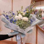 Florist holding the Natsuzora July birthday bouquet in our Surry Hills flower shop, Sydney
