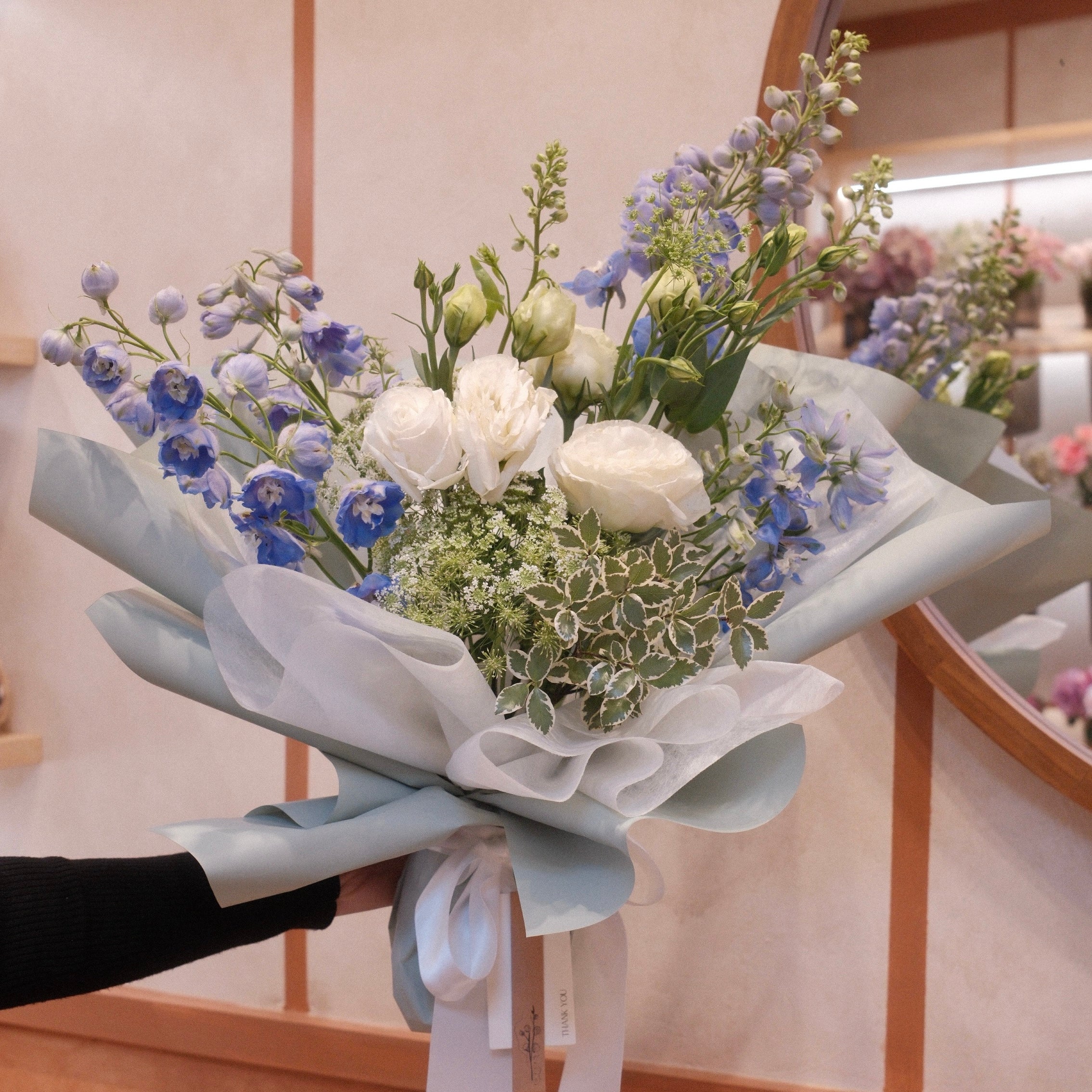 Florist holding the Natsuzora July birthday bouquet in our Surry Hills flower shop, Sydney