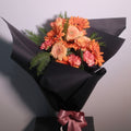 Elegant orange graduation bouquet by Hanaya Flora, a Sydney florist creating personalised graduation flowers for university ceremonies.