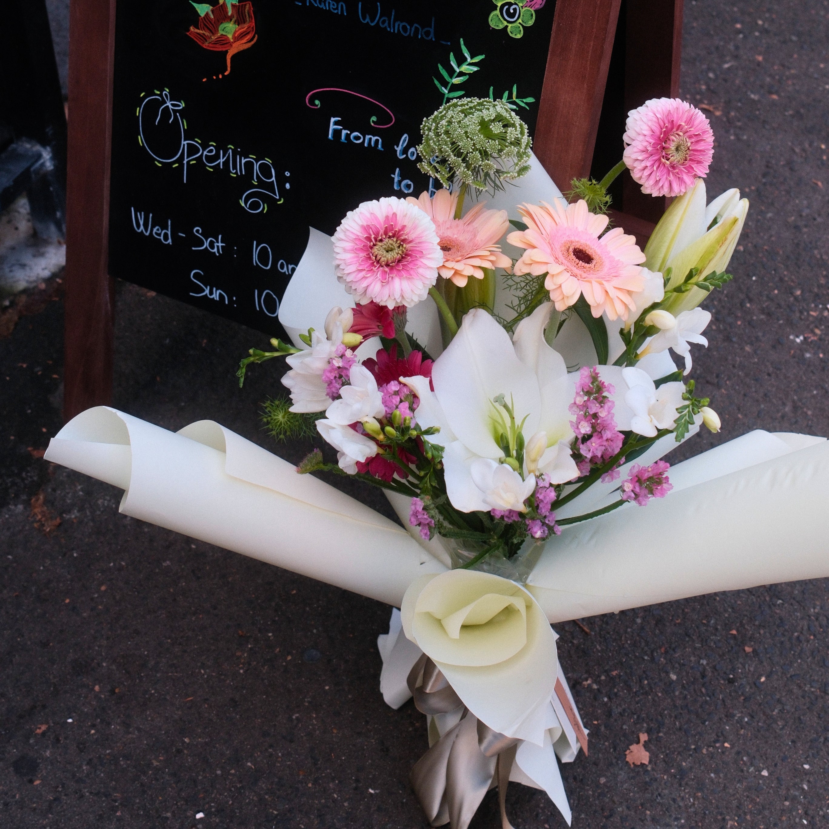 Bouquet of flowers wrapped in pale green paper, perfect flower gift for her made by Hanaya Flora, Surry Hills, Sydney.