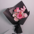 Bouquet of pink roses and calla lilies flowers wrapped in black paper with a black ribbon, Hanaya Flora, Surry Hills, Sydney.