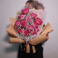 Romantic bouquet of pink roses with baby breath wrapped in brown kraft paper, Hanaya Flora, Surry Hills, Sydney.