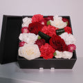 Black gift box filled with red rose, white rose, and pink preserved flowers, by Hanaya Flora, Surry Hills, Sydney.