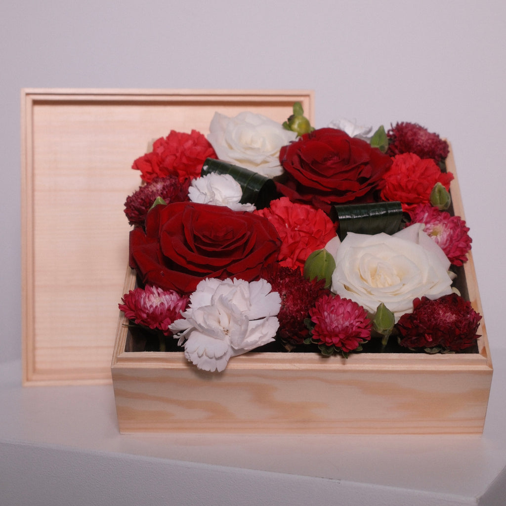 Wooden gift box filled with red rose, white rose, and pink flowers by Hanaya Flora, Sydney.