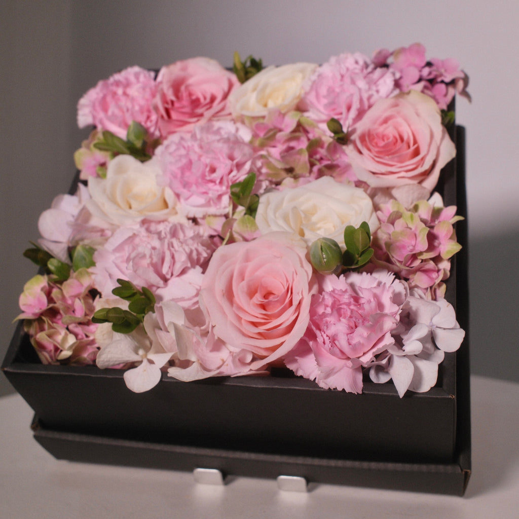 Floral arrangement with pink rose and white rose flowers in a black box, by Hanaya Flora, Sydney.