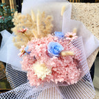 Close-up of Sakura Dream bouquet with pink preserved hydrangea, blue roses, ivory sola flower and bunny tail grass, Hanaya Flora