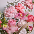 Close-up of the Home in Bloom Basket with roses, carnations and tulips