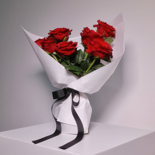 Premium flower bouquet of red roses wrapped in white paper with a black ribbon, by Hanaya Flora, Surry Hills, Sydney.