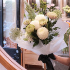 Quiet Comfort bouquet of white chrysanthemums wrapped in white paper with a black ribbon, Hanaya Flora Surry Hills