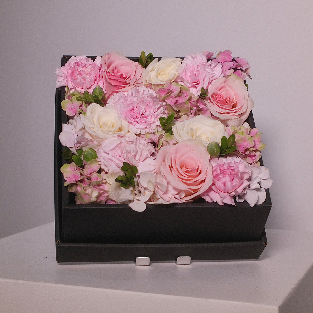 Square black gift box filled with pink rose and white rose flowers, by Hanaya flora, Sydney.