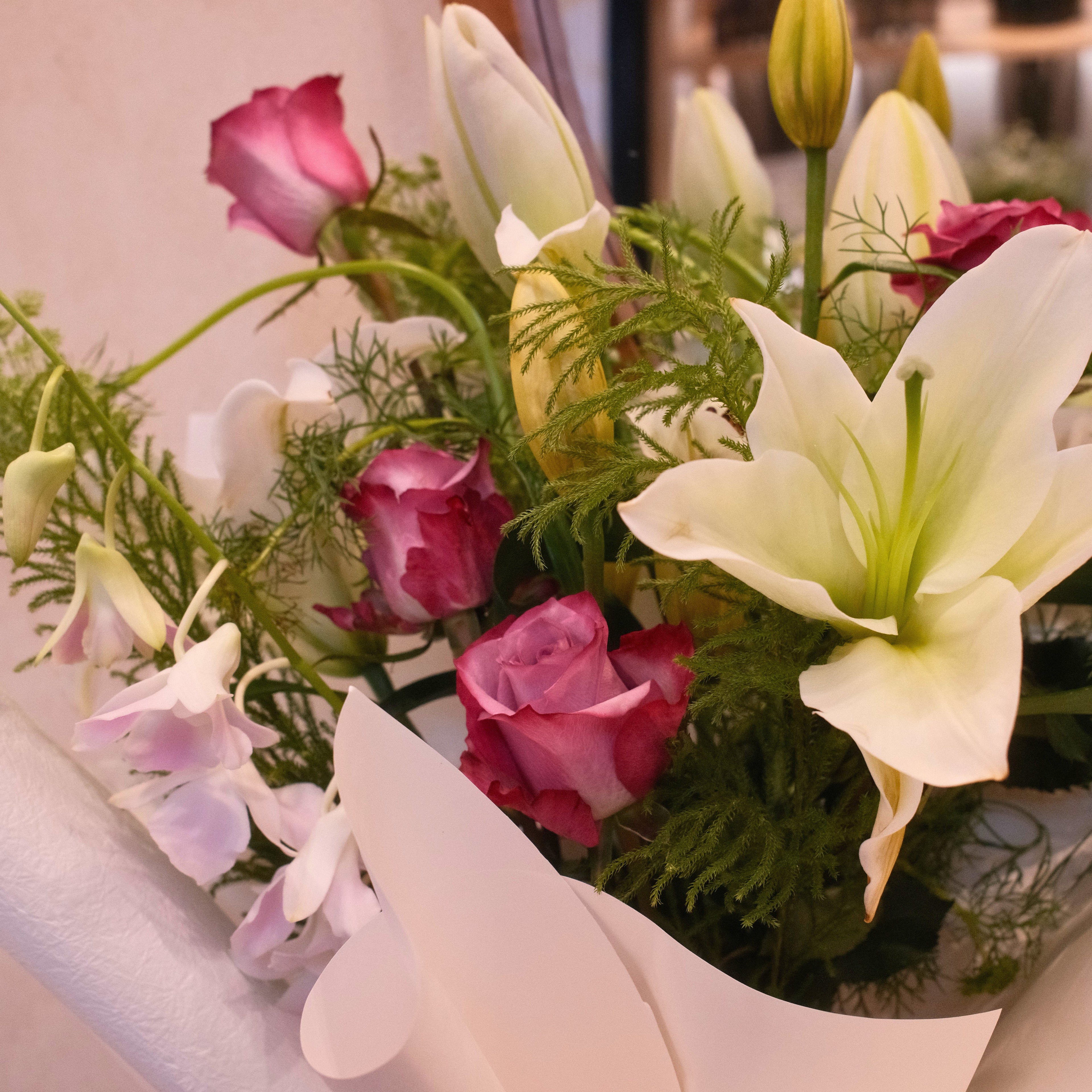 Close-up of Yasashii Grace bouquet featuring roses, white lilies and orchid, Hanaya Flora
